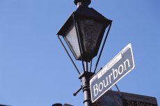 bourbon street sign against blue sky in new orleans louisiana
