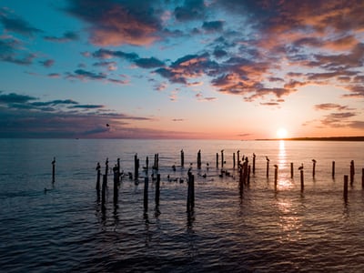 view of the ocean with dock posts in virginia beach virginia usa.